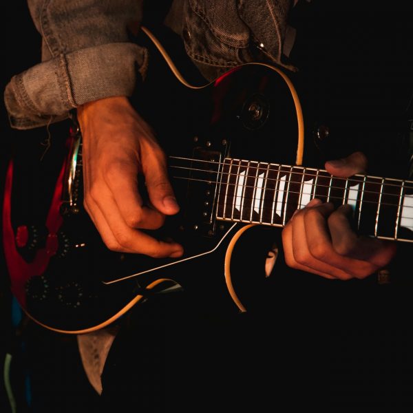 Close up of a man playing his guitar