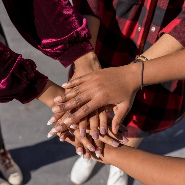 Top view of women hands joining hands